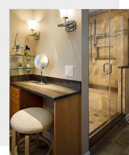 Frameless glass shower door in a bathroom with a vanity